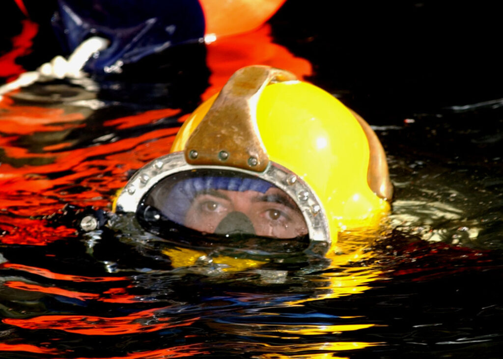 Sommozzatore della U.S. Navy con casco MK-21 e alimentazione dalla superficie prima di lavori su pali a Newport.
